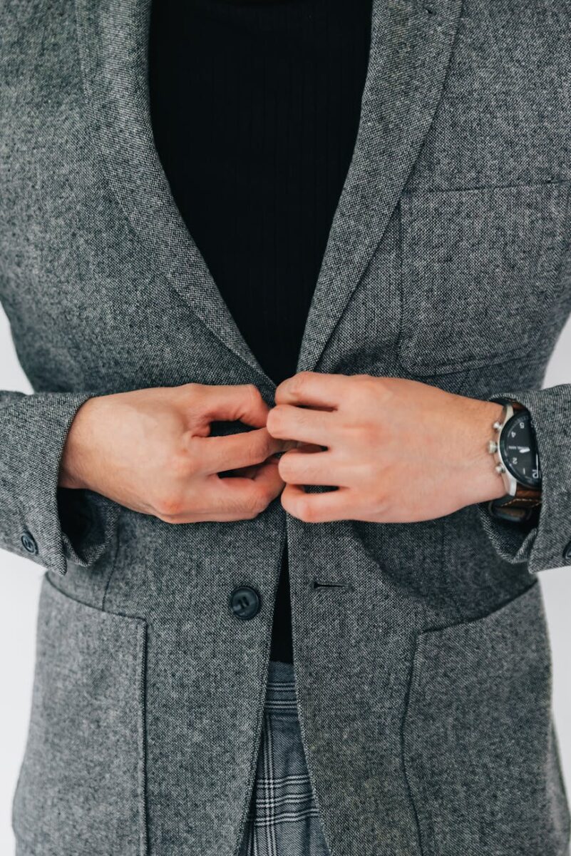 photo of a person buttoning a blazer