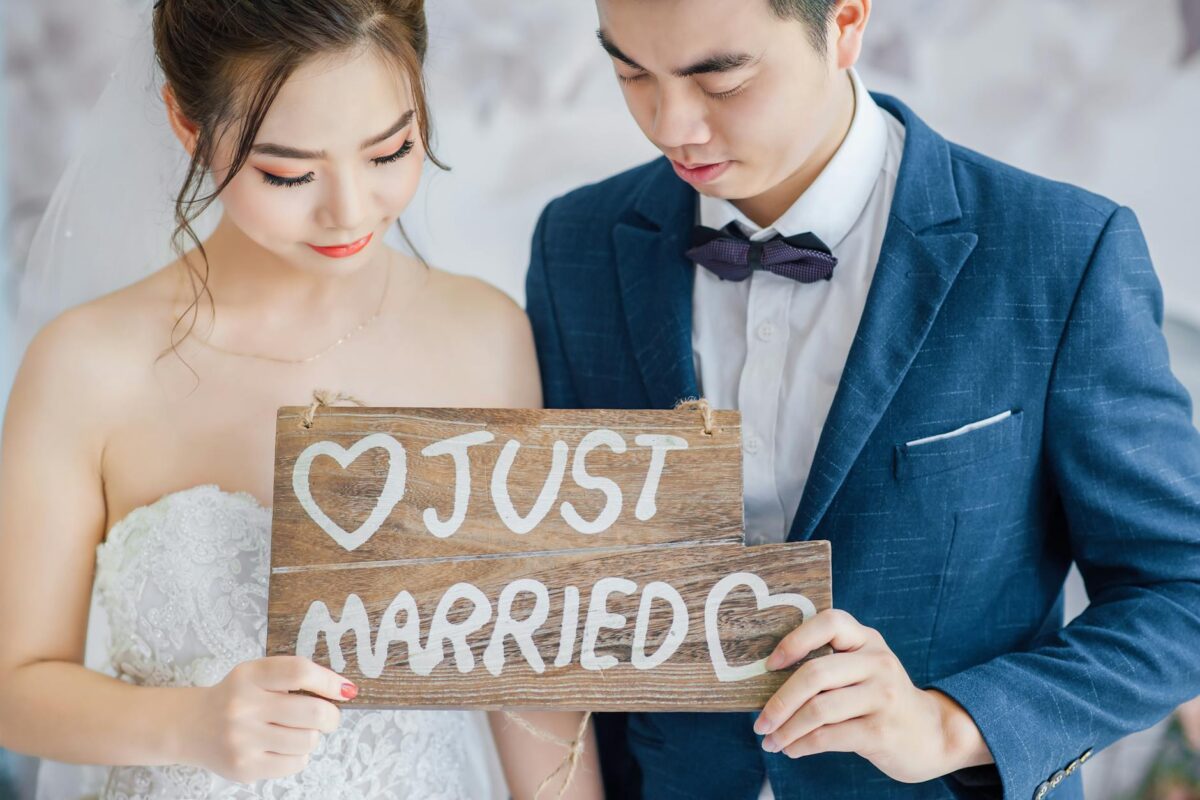 a couple holding a just married sign