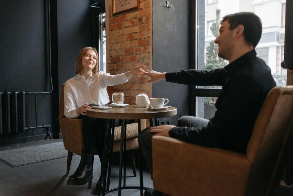 couple holding hands at the coffee shop