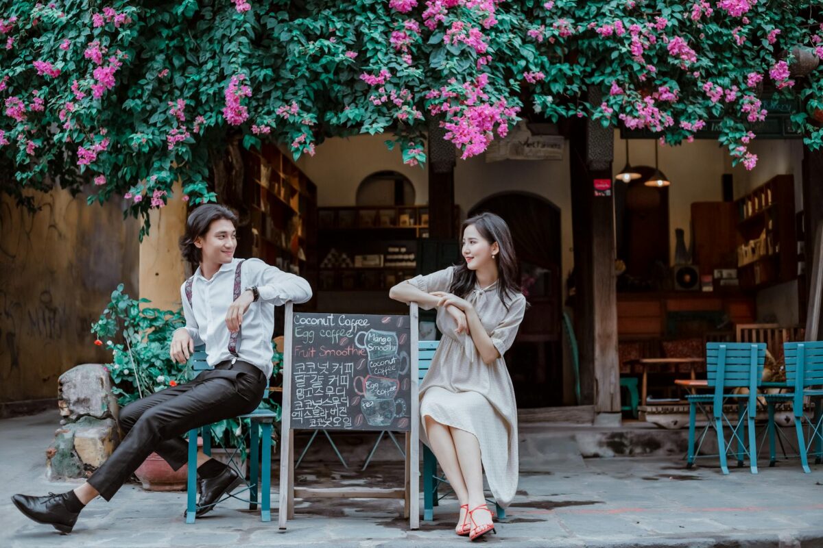a couple leaning on a menu board