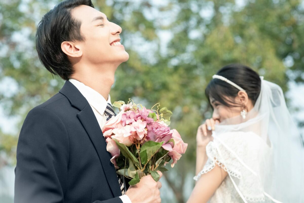 groom holding a bouquet near the bride